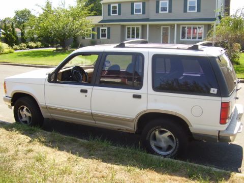 1991 Ford Explorer - A white 1991 Ford Explorer is parked on the side of a residential street.