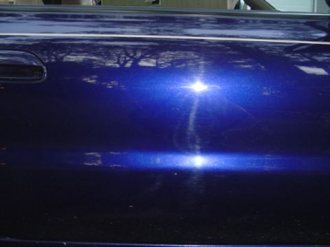 1996 Mazda MX-6 - passenger door, ding is right under the body line .. small white dot....someone hit my car with their door and ran at work.