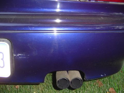1996 Mazda MX-6 - passenger side rear bumper, dent next to the license plate was there since i bought the car, not sure where the mark next to the muffler ca…