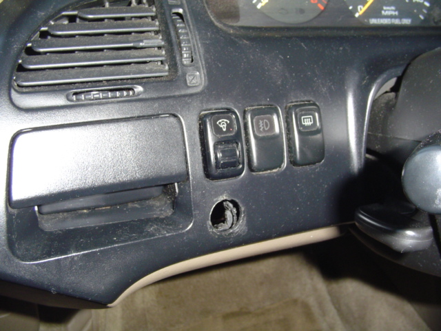 hole in dash from previous owner.. most likely for fog lights...