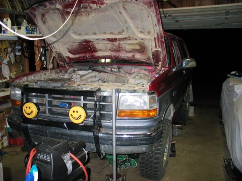 1995 Ford Bronco - Front view of a 1995 Ford Bronco with its hood open, parked inside a garage.