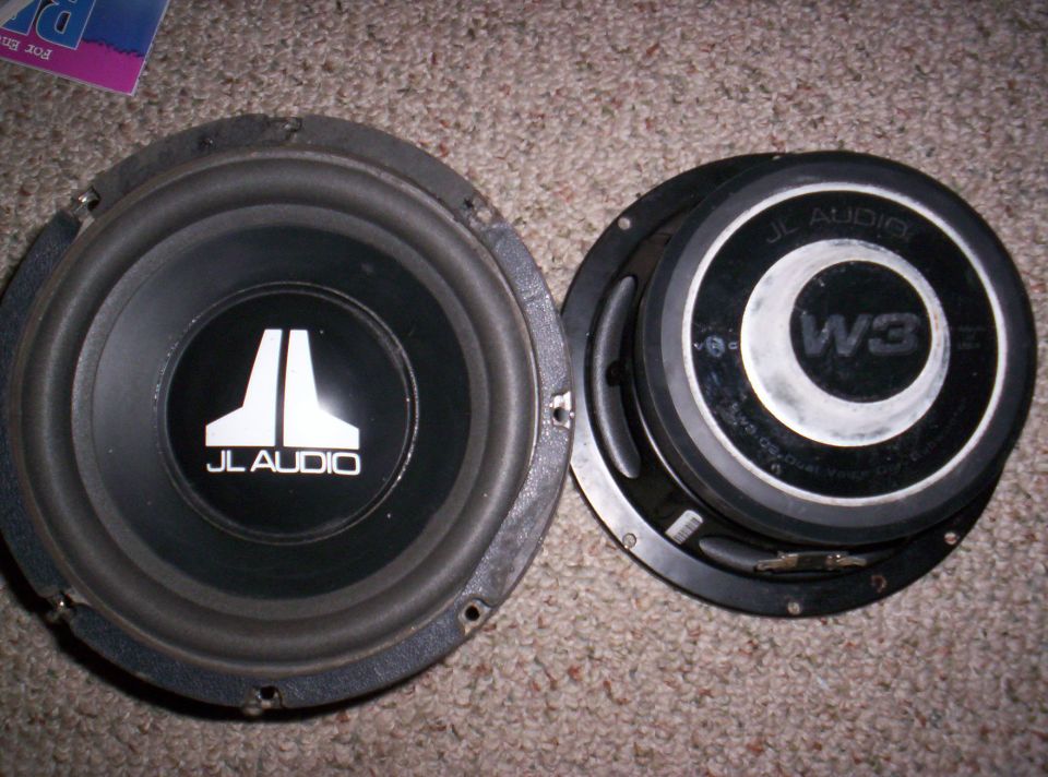 Two JL Audio W3 subwoofers on carpet