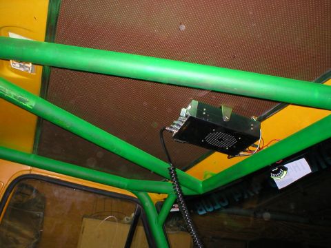 1978 Ford Bronco - Interior view of a vehicle with a roll cage and an overhead-mounted radio.