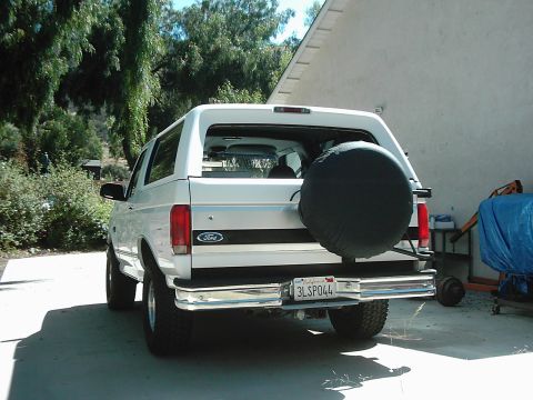 1978 Ford Bronco - Rear view of a white Ford Bronco, showing its spare tire and license plate.