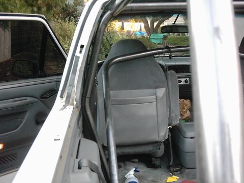 1978 Ford Bronco - Interior view of a modified SUV, showing seats and a roll cage.