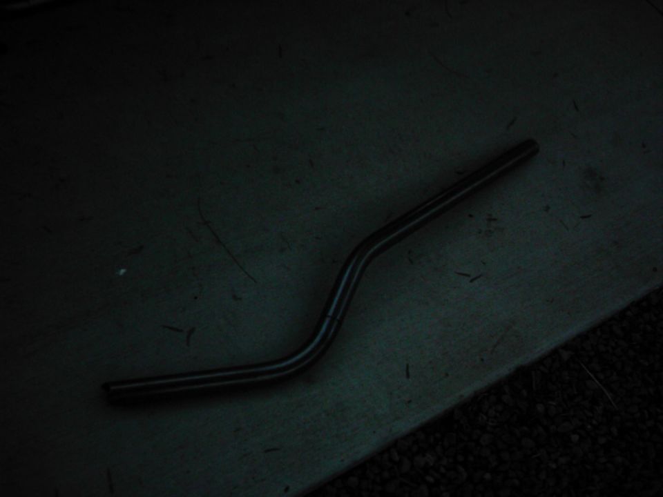 curved metal rod on a dark surface