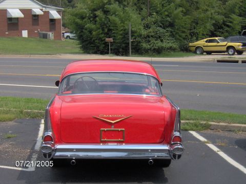 1978 Ford Bronco - Red 1957 Chevrolet Bel Air seen parked next to a yellow Ford Mustang.