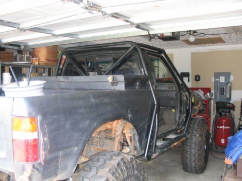1986 Ford F-150 - This modified 1986 Ford F-150 pickup truck is equipped with a full roll cage and off-road tires.