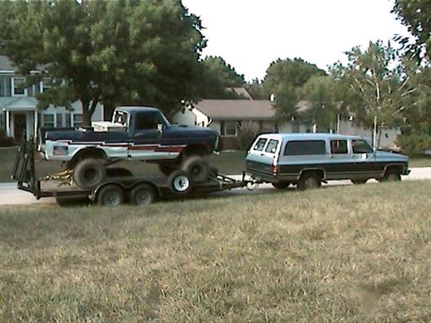 1977 Ford F-150 - A 1977 Ford F-150 pickup truck is transported on a trailer, towed by a large SUV.