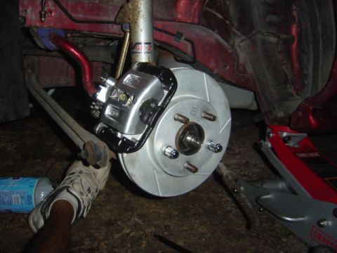 1998 Ford Taurus - A car's brake system is shown with a new rotor and caliper installed.