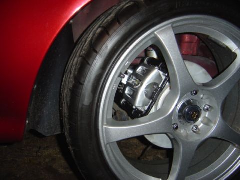 1998 Ford Taurus - Close-up of a car's wheel, showing the brake caliper and tire.