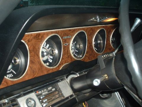 1968 Ford Thunderbird - The interior of a 1968 Ford Thunderbird shows its dashboard with multiple gauges and woodgrain accents.