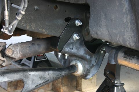 1994 Ford Bronco - Vehicle suspension components, including a bracket and axle, are shown supported by jack stands.