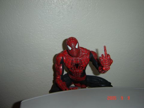 1993 Ford Bronco - A Spider-Man action figure is positioned on a surface, giving the middle finger.