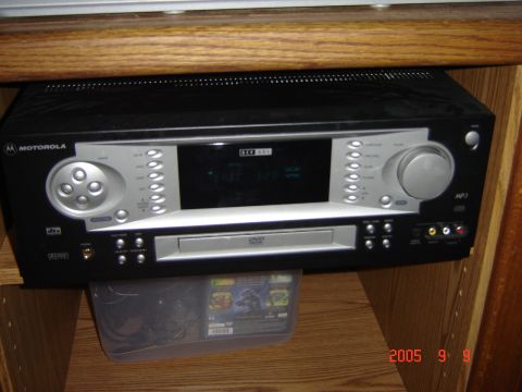 1993 Ford Bronco - A Motorola DVD player and receiver unit is shown installed on a wooden shelf.