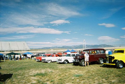 1972 Ford Ranchero - Outdoor car show a variety of classic vehicles under a blue sky with clouds.