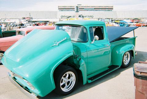 1972 Ford Ranchero - A teal 1956 Ford F-100 pickup truck is displayed with its hood open.