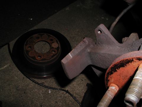 1992 Ford Taurus - A close-up view of a brake rotor and spindle assembly, likely removed for maintenance or repair.