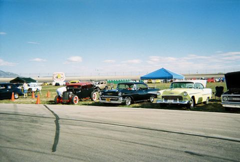 1972 Ford Ranchero - Several vintage cars are gathered under a clear blue sky at an outdoor event.