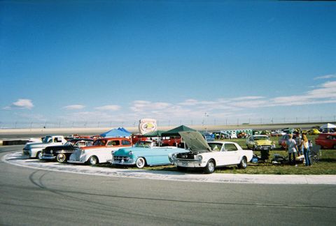 1972 Ford Ranchero - A collection of vintage automobiles are displayed under a clear blue sky at an outdoor event.