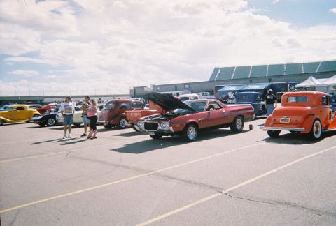 1972 Ford Ranchero - A red 1972 Ford Ranchero is displayed with its hood up at an outdoor car event.