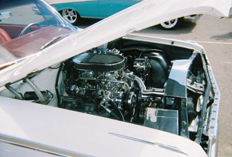 1972 Ford Ranchero - A highly customized V8 engine is displayed with the hood open, parked next to another vehicle.