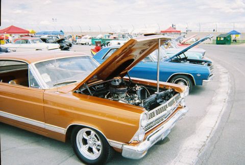 1972 Ford Ranchero - A 1966 Ford Ranchero is displayed with its hood open, revealing the engine, at an outdoor car show.