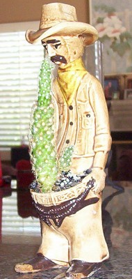 1995 Ford Bronco - A decorative cowboy statue holding a potted cactus is shown indoors.