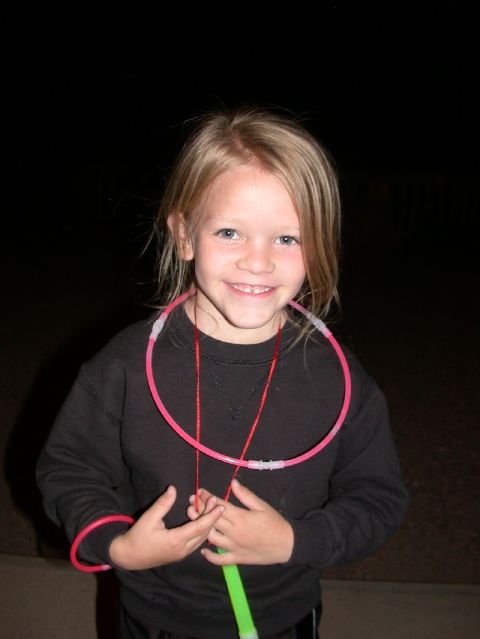 1994 Ford Bronco - A young child smiles while wearing multiple glow necklaces and bracelets.
