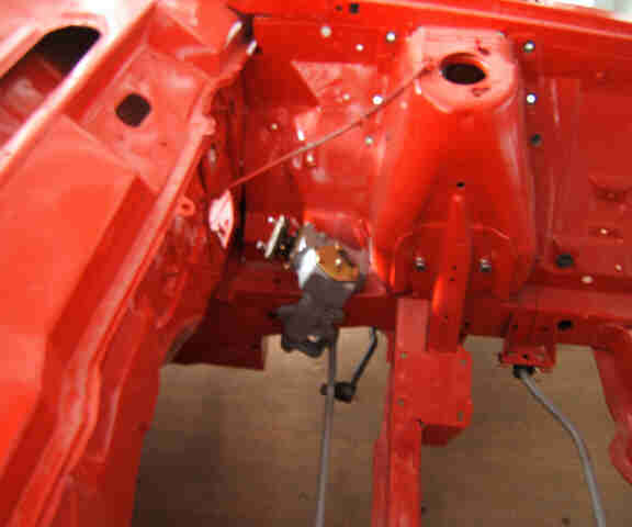 Red-painted engine bay frame with steering box mounted on shell