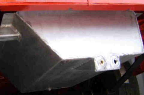 1967 Ford Ranchero - A close-up view of a vehicle's fuel tank, showing its metallic construction and connection ports.