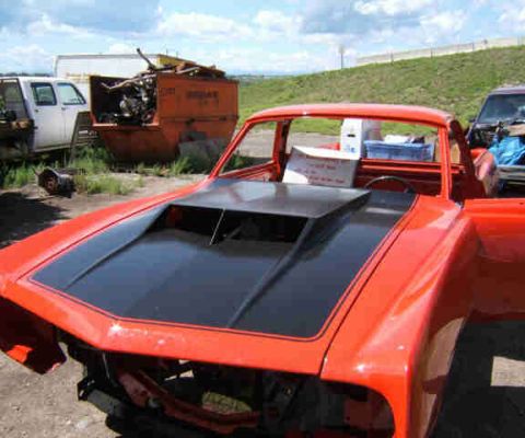 1967 Ford Ranchero - This 1967 Ford Ranchero is undergoing restoration, with its doors open and a prominent black hood scoop.
