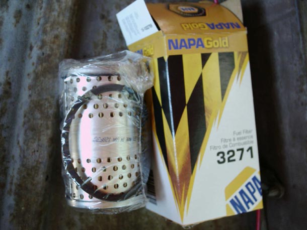 NAPA Gold fuel filter element 3271 next to its box on a workbench