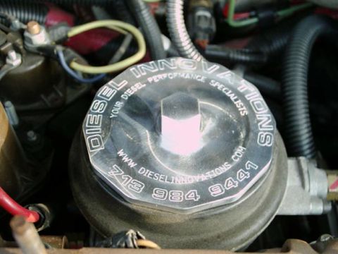2002 Ford F-250 - Close-up of a chrome fuel filter housing with company branding and contact information visible.