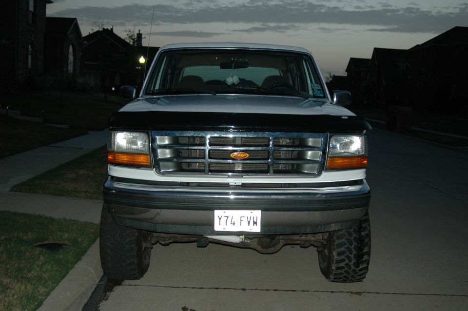 Front view of a white Ford F-150 pickup truck with a black bug deflector. License plate Y74 FVW