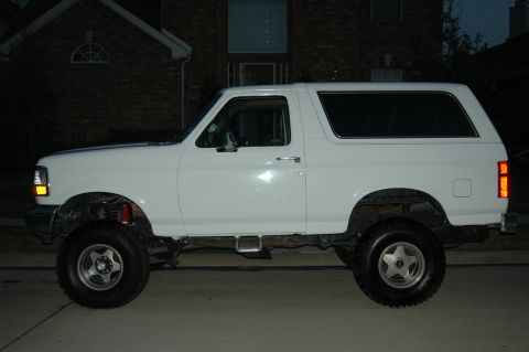 1992 Ford Bronco - Side profile of a white 1992 Ford Bronco, a classic SUV known for its design and off-road capabilities.
