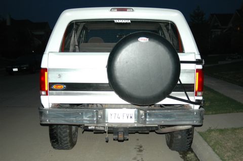 1992 Ford Bronco - Rear view of a white 1992 Ford Bronco, equipped with a spare tire and trailer hitch.