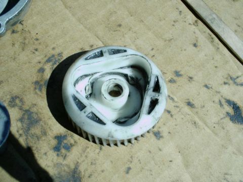 1988 Ford Bronco - A close-up view of a damaged window motor gear, showing wear and tear on its components.
