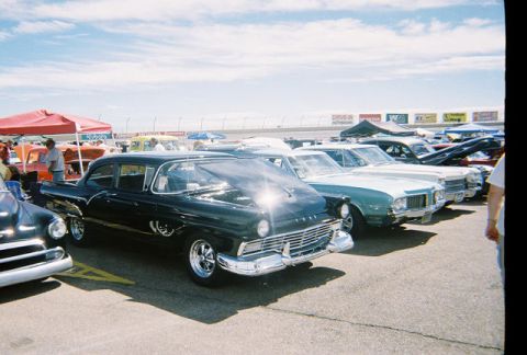1972 Ford Ranchero - Several classic cars are lined up at an outdoor event, with a black Ford Fairlane in the foreground.