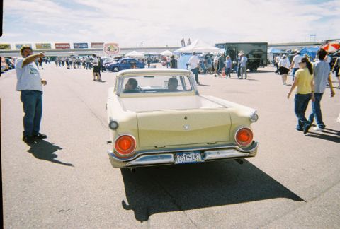 1972 Ford Ranchero - Rear view of a yellow 1959 Ford Ranchero pickup truck at an outdoor event.