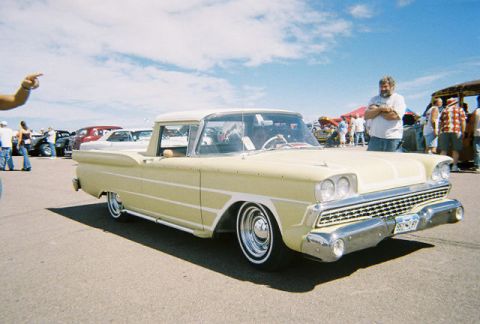 1972 Ford Ranchero - A man points towards a vintage car at an outdoor event. Other vehicles and people are visible in the background.