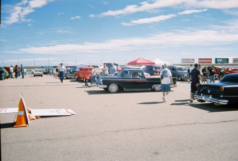 1972 Ford Ranchero - A black 1959 pickup truck is seen from the side at an outdoor car show with other vehicles present.