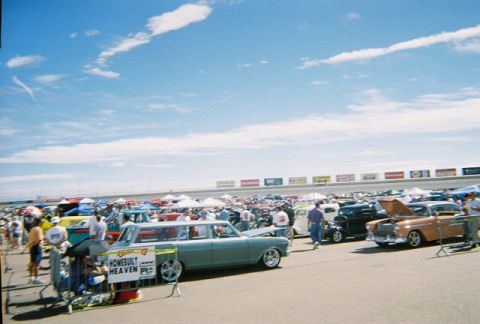 1972 Ford Ranchero - A light blue station wagon, likely from the 1960s, is displayed at an outdoor car show with many other vehicles and tents.