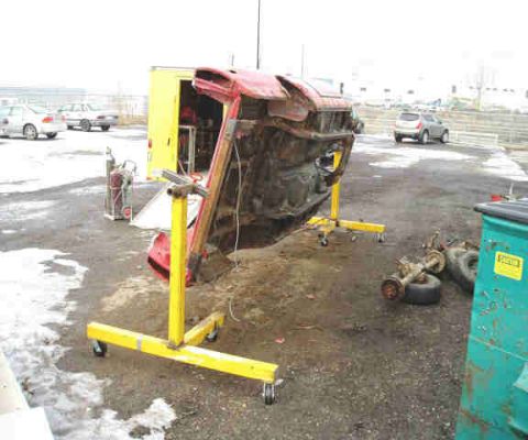 1967 Ford Ranchero - Body of a 1967 Ford Ranchero is mounted on a yellow engine stand for restoration.