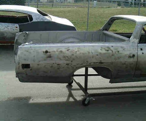 1967 Ford Ranchero - Two vehicle bodies, one a Ford Ranchero, are in a state of repair or restoration.