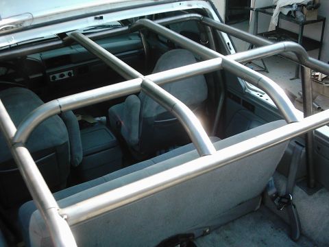 1978 Ford Bronco - Custom roll cage installed inside a vehicle's interior, showing grey seats and dashboard details.