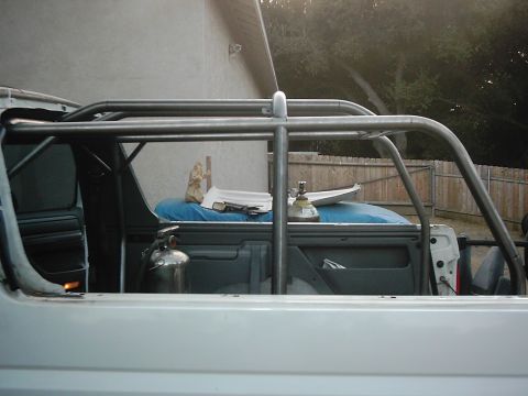 1978 Ford Bronco - Roll cage installed in pickup truck bed with fire extinguisher.