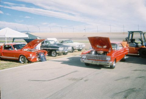 1972 Ford Ranchero - A red 1964 Ford Falcon is displayed with its hood up at an outdoor event.