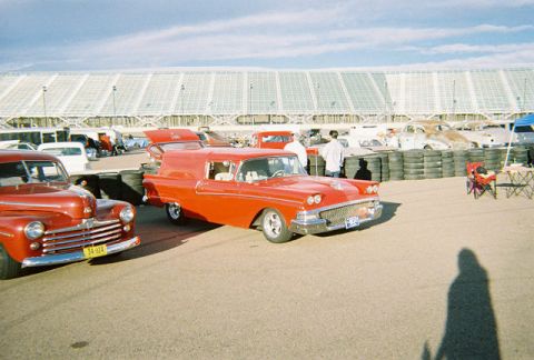 1972 Ford Ranchero - A red 1958 Ford sedan delivery van is parked at an outdoor event with other vehicles.