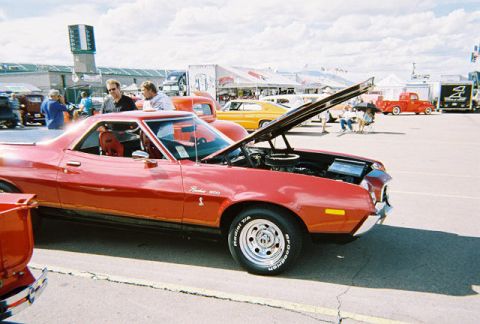 1972 Ford Ranchero - A red 1972 Ford Ranchero is displayed with its hood open at an outdoor event.